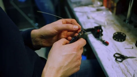 Male hands prepare wire for the electronic cigarette. Stock Footage 73016675