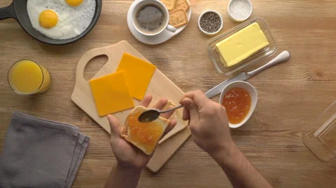 Male hands preparing breakfast toast with jam, top view Stock Footage 67535241