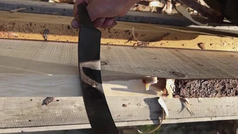 Male hands process boards from the bark with a hand tool. Vídeos de archivo 247194748