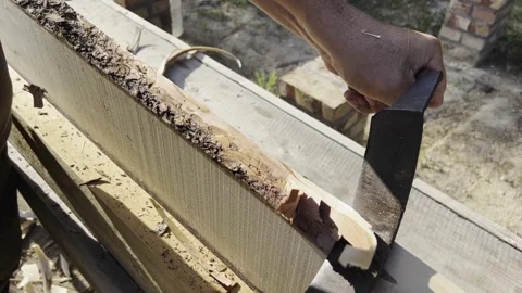 Male hands process boards from the bark with a hand tool. Slow motion video. Stock-Footage 247194826