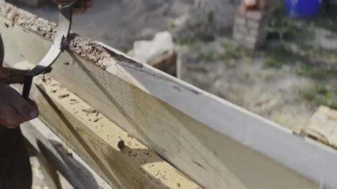Male hands process boards from the bark with a hand tool. Stock-Footage 249836896