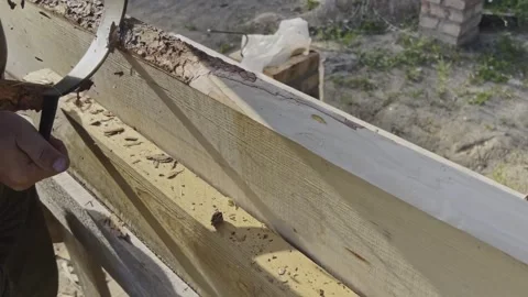 Male hands process boards from the bark with a hand tool. Video stock 251198302