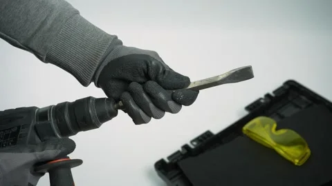 Male hands in protective gloves insert a drill bit into an electric perforator Stock Footage 287244477