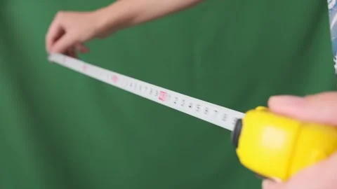 Male hands pull measuring tape out of tape measure Video stock 253971266