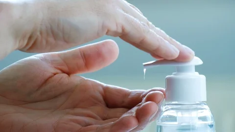 Male hands push the dispenser and squeeze out liquid soap Stock Footage