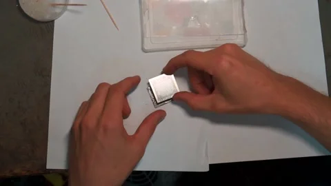 Male hands put a stencil on a micro Stock Footage 142375442