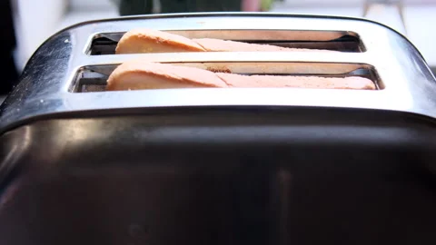Male Hands Putting Bread into Toaster. Closeup. Stock Footage 243938529