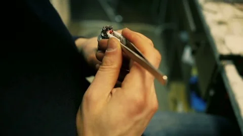 Male hands regulate electronic cigarette coils. Stock Footage 72930124