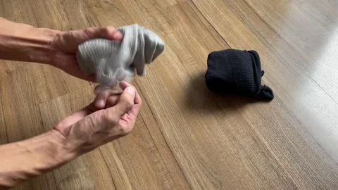 Male hands rolling socks. Folding cloth for travel concept Video stock 248407225