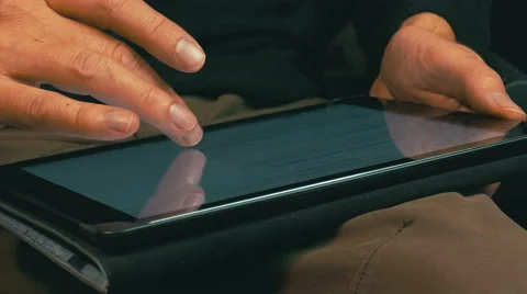Male Hands Scrolling on a Tablet Computer Stock Footage 47783598