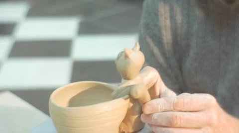 Male Hands Sculpt a Tail to a Clay Cat Statuette Fixed to a Pot Man is Putting Stock Footage 59129686