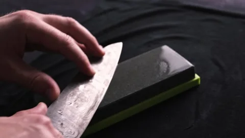 Male Hands Sharpening Kitchen Knife With Whetstone Stock Footage 258481268