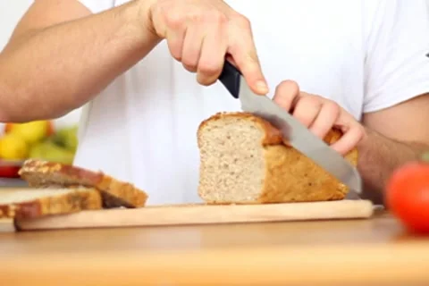 Male hands slicing bread, slow motion Stock Footage 8983541