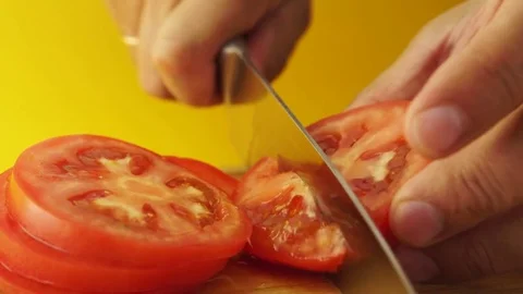 Male hands slicing red ripe tomatoes Stock Footage