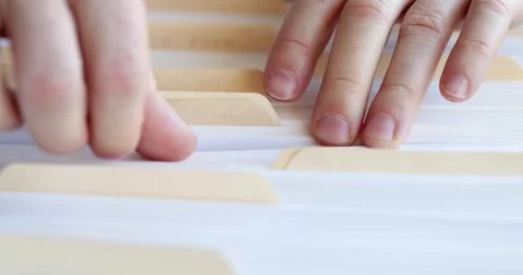 Male hands sorting through folders with business documents Stock Footage 261695452