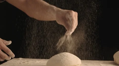 Male hands sprinkle a piece of baking dough with flour. Stock Footage 152442008