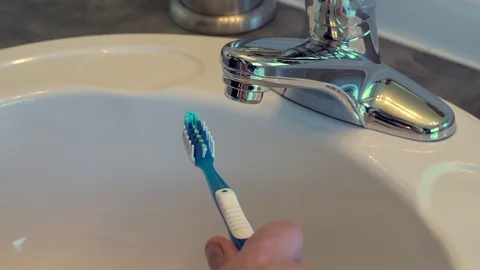 Male hands squeeze a half drop of toothpaste from an empty tube. Stock Footage 69969548