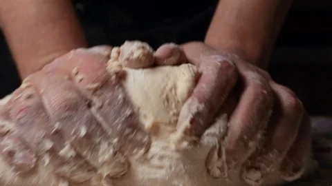 Male hands stack a large mass of dough Stock Footage 124960196