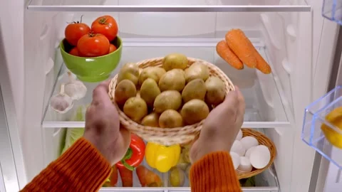 Male hands take a basket of organic potatoes from the fridge Stock Footage 260769953