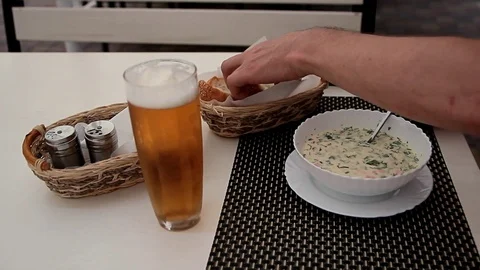 Male hands take bread and start eating cold soup Stock Footage 124622684