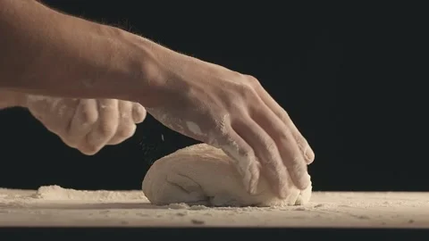 Male hands take off a piece of baking dough from wooden table Stock Footage 152447820