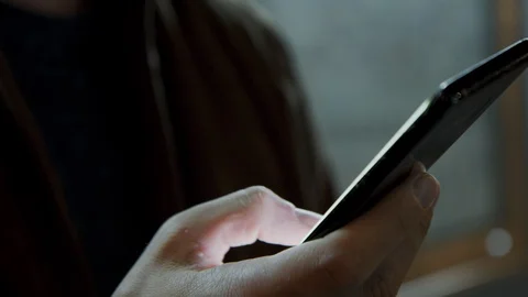 Male hands texting message on a cell phone at the night city on background Stock-Footage 128033221