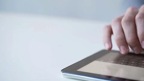 Male hands texting on tablet pc, using modern mobile gadget for communication Stock Footage 72357773