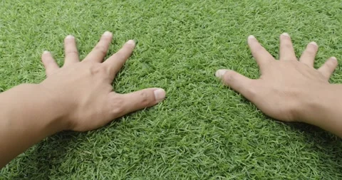 Male hands is touching artificial lawn grass. Stock Footage 252171669