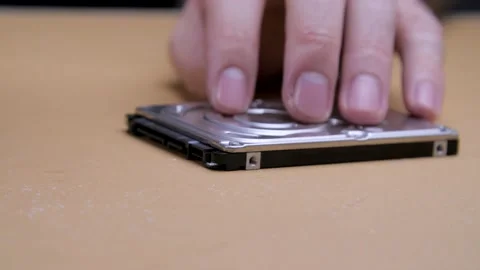 Male hands twists the screw on a computer hard drive with a screwdriver. 動画素材 132647971