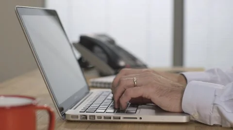 Male hands typing and using the trackpad on a silver laptop computer in office 스톡 동영상 68446900