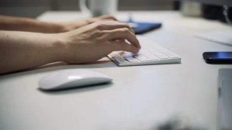 Male hands typing on a computer keyboard. Clean white desk. Office or Home. Stock Footage 158891164