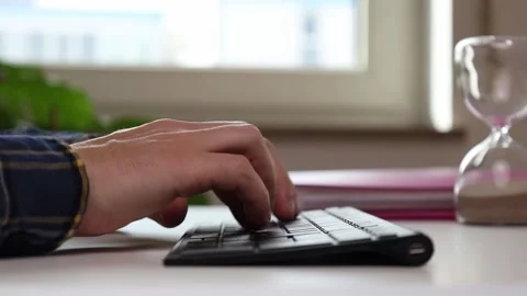 Male hands typing on the keyboard at the table Video stock 244599161