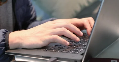 Male hands typing on laptop computer from left Stock Footage 89461783
