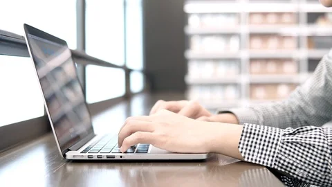 Male hands typing on laptop computer keyboard in working space Stock Footage 91007371
