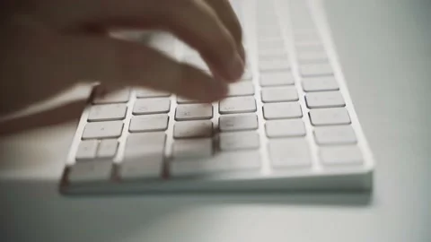Male hands typing on a white computer keyboard 動画素材 158891051