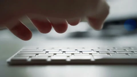 Male hands typing on a white computer keyboard 動画素材 158891245