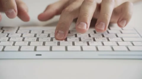 Male hands typing on a white computer keyboard. Slide left. Stock Footage 158891260