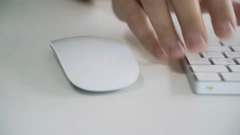 Male hands typing on a white computer keyboard. Slide right. Stock Footage 158891317