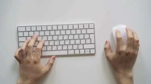 Male hands typing on a white computer keyboard. Table top view. Stock Footage 158891360