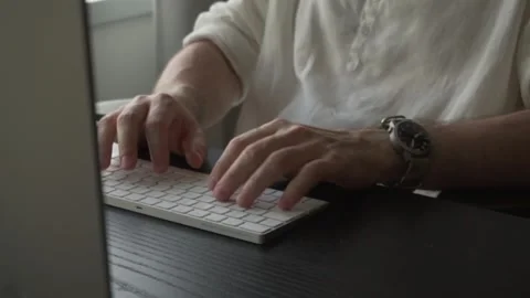 Male hands typing on white wireless keyboard. Close up shot Stock Footage 249996137