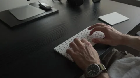Male hands typing on white wireless keyboard. Close up shot Stock Footage 249996139