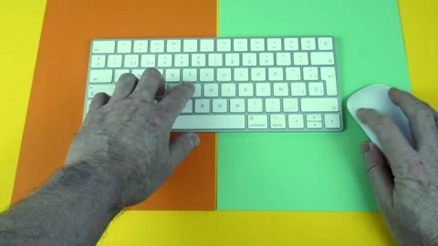 Male hands typing on a wireless keyboard and using a mouse 스톡 동영상 329015108