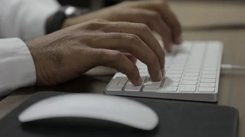Male hands typing working with  computer keyboard at table at home, Stock Footage 146942131