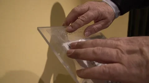 Male hands using the braille system to read what the museum artifact is abou Stock Footage 140988701