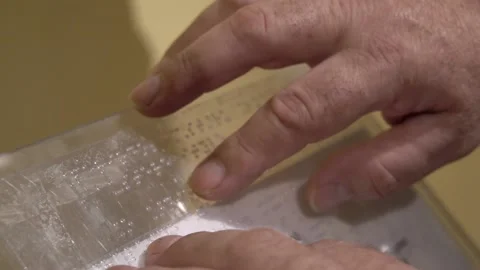 Male hands using the braille system to read what the museum artifact is abou Stock Footage 140991170
