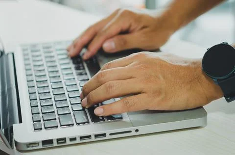 Male hands using computer for information or social media and communication b 스톡 사진