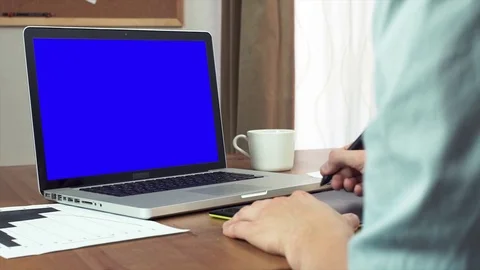 Male hands using a digital drawing tablet and a laptop computer at home Stock Footage 81879147