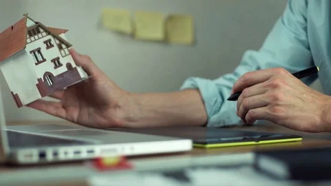 Male hands using digital tablet creating housing project on laptop. Video stock 81880965