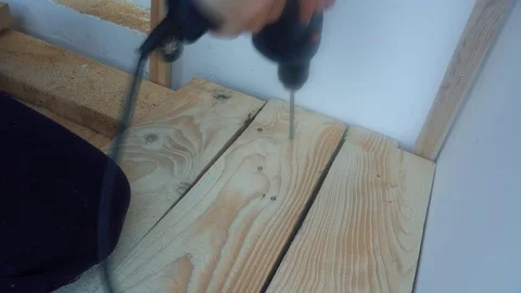 Male hands using a drill for drilling holes in a wooden Board Video stock 75913821