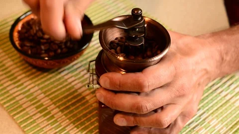 Male hands using a hand mill to grind coffee beans Video stock 102215213